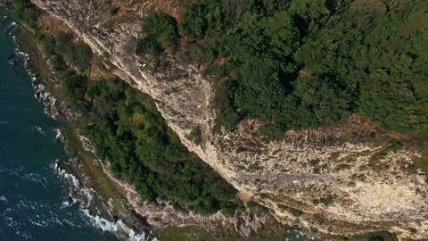 Drone shot in rotation of a cliff on Lake Garda Stock Footage