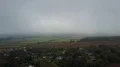 Drone shot rotation gray clowdy foggy weather over countryside village landscape 4k or 4k+ Resolution