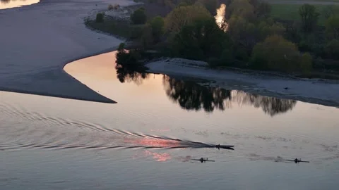 Drone shot of rowing trails creating glittery water reflections at sunset o.. Stock Footage 317810713