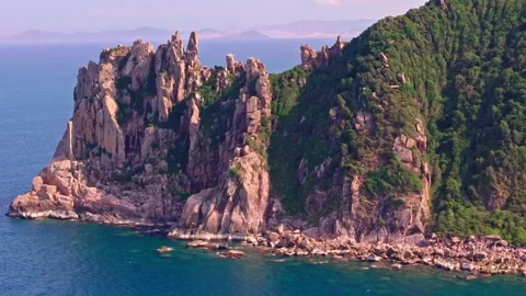 Drone Shot of Rugged Cliffs and Serene Waters of a Vietnamese Island Stock Footage 279207468