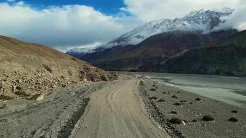 Drone shot of rustic road alongside the shyok river in Ladakh. Stock Footage 310807035
