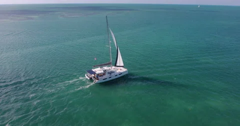 Drone Shot of sailboat exploring tropical Caribbean ocean Exclusive Island Видео 146474932