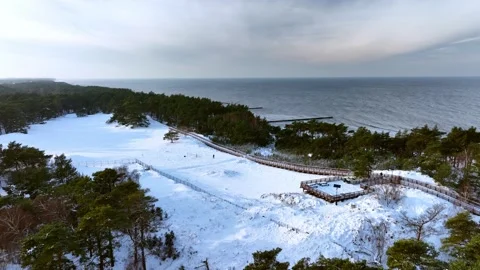 Drone shot of a sand dune covered with snow by the Baltic Sea Stock Footage 260637583