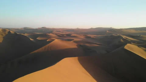 Drone shot of sand dunes in Peruvian desert landscape at sunset Stockbeeldmateriaal 144455577