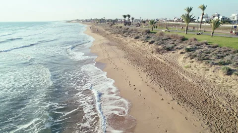 Drone shot of sandy beach early morning, calm waves, deserted beach Stock Footage 311587327