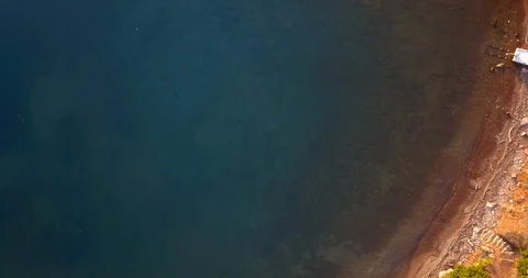 Drone shot of sea bathing sandy and rocky coastline Stock Footage 107950535