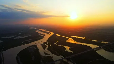 Drone shot of the setting sun over the Yellow River and the river plain Stock Footage 296369687