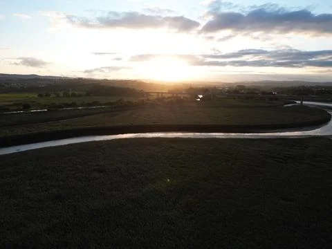 Drone shot of setting sun over Exe Estuary, unedited Stock Photos