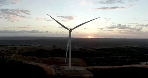 Drone shot of Silhouettes windmills, large orange sun disc summer lens Stock Footage 160945344