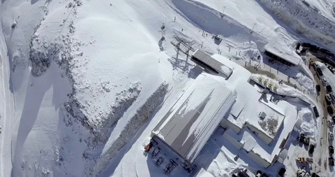 Drone shot of ski resort base station, parking lot and gondola with people Stock Footage 104655006