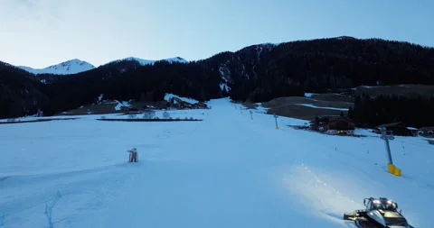 Drone Shot of a ski resort while a snowcat prepare the slope Stock Footage 283564728