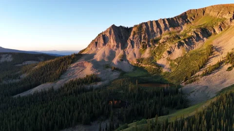 Drone Shot of Slopes of Rocky Mountains on Golden Hour Sunlight, Crested Butte Stock Footage 346105748