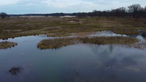 Drone shot of small blue lake and sky reflection on a cloudy day Hilversum Stock Footage 147204089