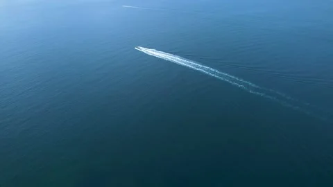 Drone shot of a small boat sailing on deep turquoise water The Concept of l.. Stock Footage 335762874