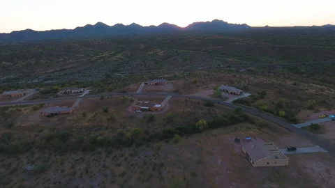 Drone shot of small town located in the middle of a desert with mountains Stock Footage 223323459