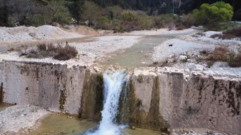 Drone Shot of a Small Waterfall and Traditional Stone Dam 動画素材 305236448