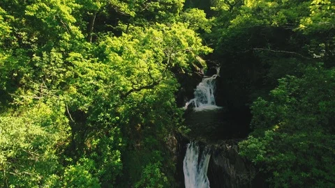 Drone shot of a small waterfall in Wales Stock Footage 90538476