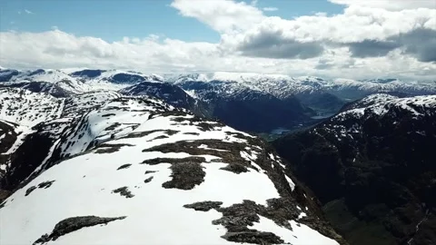 Drone shot of snow capped mountain peaks in Norway Stock Footage 157697079