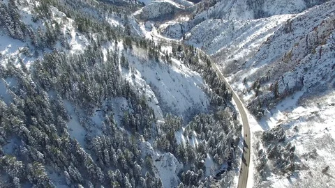 Drone shot of Snow-capped mountains with road intersecting Stock Footage 100262576