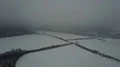 Drone shot snow white and gray foggy winter weather at small village landscape 4k or 4k+ Resolution