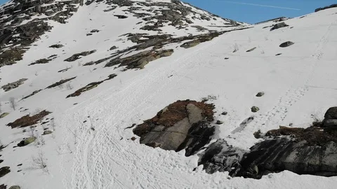 Drone shot of snowy mountains, path to Trolltungaga / Troll's Tongue, Norway Stock Footage 91105219
