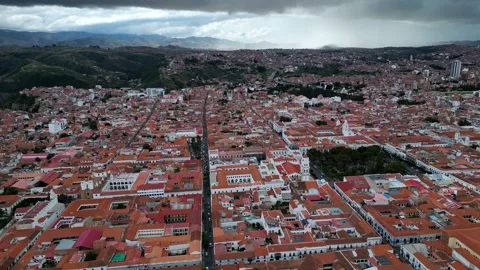 Drone shot soaring above red tiled roofs and colonial buildings around Sucre Stock Footage 341316489