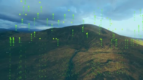 Drone shot starting hill centering green code rising, thickening then lifting Stock Footage 334115441