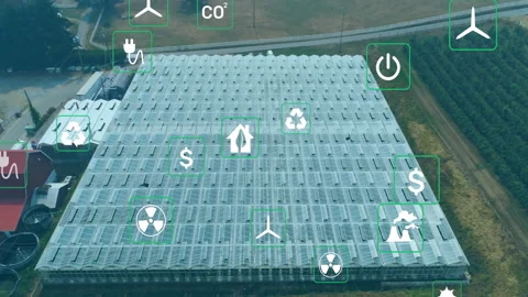 Drone shot starting icon swap, greenhouse panels showing energy symbols Stock Footage 312771493