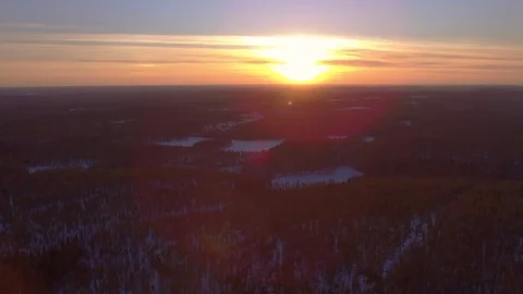 Drone shot of a stunning spring sunset over a vast boreal forest with Stock Footage 106238509