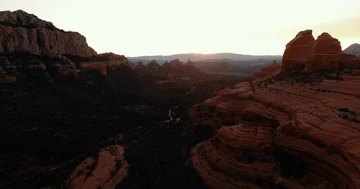 Drone Shot of Sun Setting behind Mountain Boulders Stock Footage 85753470