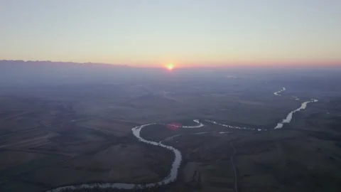 Drone shot of sun setting down behind Carpathian mountains 4k Stock Footage 165688612