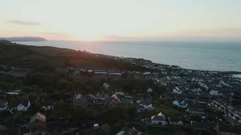 Drone Shot Of Sun Setting Over Small Coastal Town Stock Footage 252596607