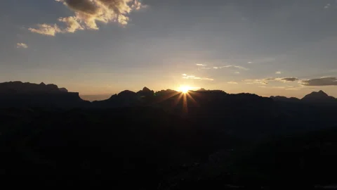 Drone shot of the sun star during sunset with the silhouette of the dolomites Stock Footage 263267421