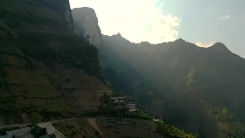 Drone Shot with Sunrays over a small Mountain Village – Ha Giang, Vietnam Video stock 313798370