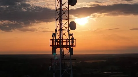Drone shot of sunset behind cell tower, stock footage Stock Footage 338187407