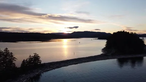 Drone Shot of Sunset with Camper Van on the Shore and Sail Boat in Background Stock Footage 233470122