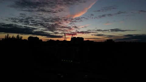 Drone shot of sunset in the city through electric wires Stock Footage 227124704