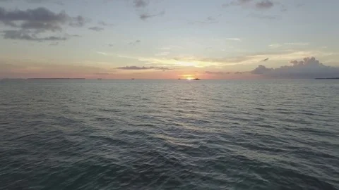 Drone shot of sunset just above the surface of sea Stock Footage 81706448