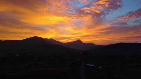 Drone shot of sunset over a mountain with bright colours 4K30 库存影片 332893415