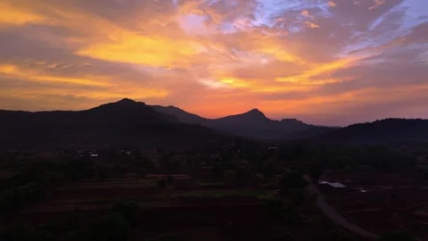 Drone shot of sunset over a mountain with bright colours 4K30 스톡 동영상 332893417