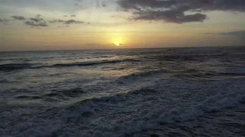 Drone Shot Sunset Over Ocean and Black Sand Beach Stock Footage 144046716