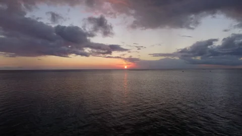 Drone Shot of Sunset Over the Ocean with Clouds on the Horizon Stock-Footage 297039158