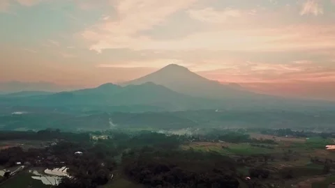 Drone shot of Sunset view with Mountains, countryside with orange sky Stock Footage