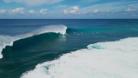 Drone Shot of Surf Wave Breaking with Rainbow Spray Stock Footage 325482003