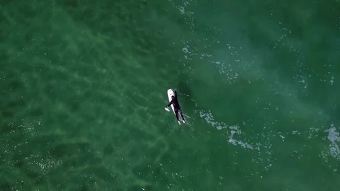 Drone shot of a surfer at a beach close to Jæren, Norway, down Stock Footage 84095109