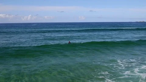 Drone shot of a surfer at a beach close to Jæren, Norway, back Stock Footage 84095935