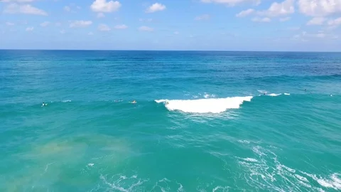 Drone shot of Surfers catching waves Stock Footage 89927253