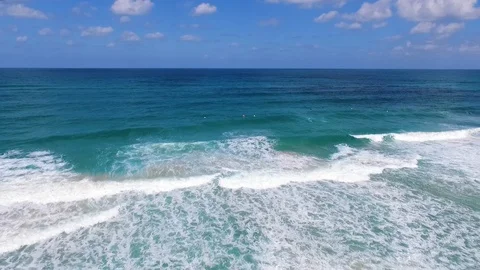 Drone shot of Surfers catching waves Stock Footage 89927310