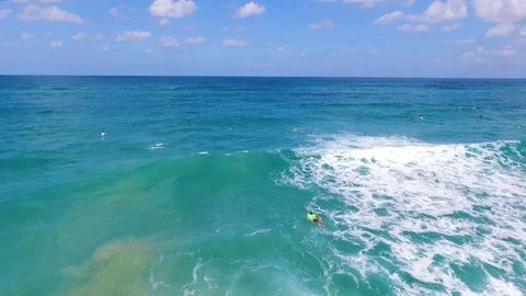 Drone shot of Surfers catching waves Stock Footage 89927352