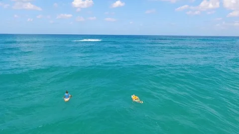 Drone shot of Surfers catching waves Stock Footage 89927735